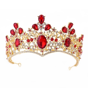 Detailed macro view of Baroque gold bridal crown with large red crystals and white rhinestones