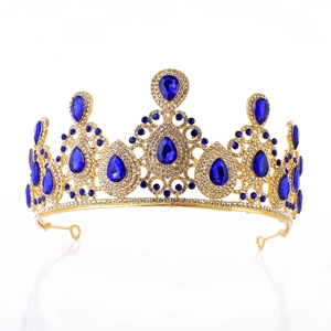 Detail of gold bridal crown with blue teardrop rhinestones and sparkling crystal accents