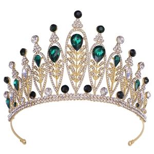 Macro detail of luxury gold bridal tiara with green teardrop gems and rhinestones