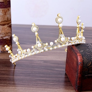 Elegant vintage bridal tiara with pearls and crystals on golden alloy frame