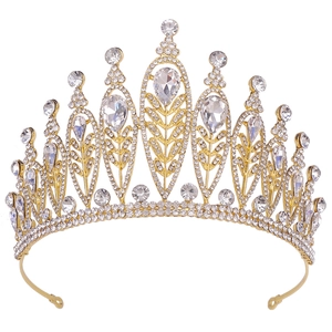 Detailed close-up of golden alloy crown with sparkling rhinestones and leaf motifs