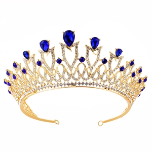Close-up of golden bridal crown with blue teardrop rhinestones and clear crystals