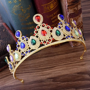 Macro detail of a vintage gold crown with colorful water-drop gems and white rhinestones