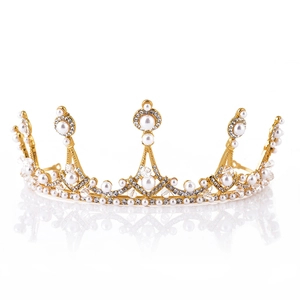 Detailed view of bridal crown with golden alloy, white pearls, and sparkling rhinestones