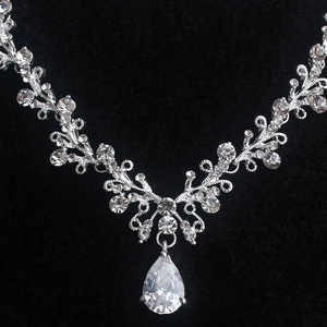 Macro shot of silver bridal necklace with pear-cut rhinestone and sparkling crystal vine