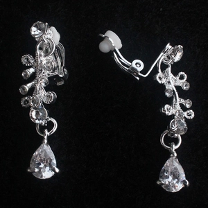 Detail of silver alloy clip-on earrings with clear zircons and drop pendants