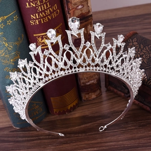 Close-up of a silver bridal tiara with sparkling pear-shaped rhinestones on vintage books