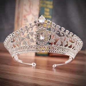 Detailed macro view of silver bridal tiara with sparkling rhinestones on vintage wood