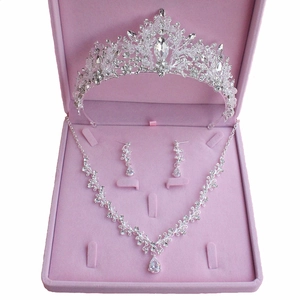 Close-up of bridal tiara, necklace and earrings set in a pink velvet jewelry box