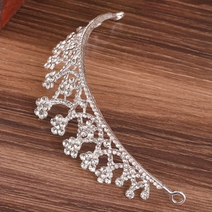 Elegant silver rhinestone tiara for bridal or kids weddings on dark wooden surface