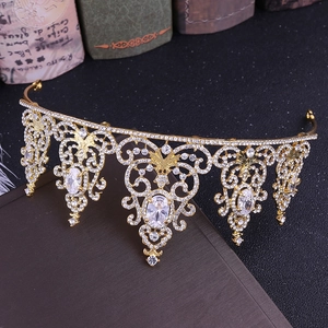 Detailed macro view of baroque gold crown with white zircons and intricate cutout metalwork