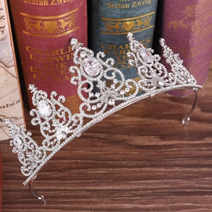 Close-up of bridal crown featuring silver scrollwork and four teardrop-shaped crystals