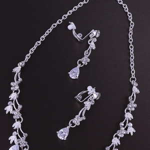 Macro shot of silver bridal jewelry set with pear-shaped rhinestones and drop crystals