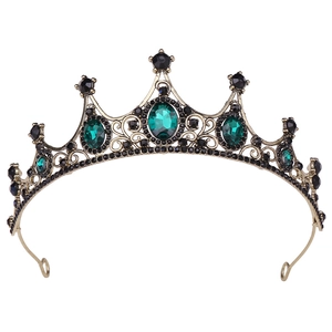 Detailed view of emerald green crystal stones on a bronze vintage bridal tiara