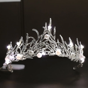 Detailed view of LED bridal crown with silver branches, white pearls and warm lights