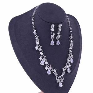 Detail of silver teardrop bridal jewelry set with sparkling cubic zirconia on a mannequin