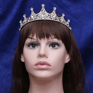 Front view of bridal crown with sparkling rhinestones and oval gemstones on a model