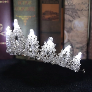 Luxury silver bridal crown with glittering rhinestones and bright glowing LED lights