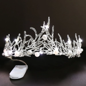 Detail of LED bridal tiara showing white pearls and crystal branch with battery pack