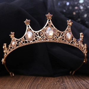 Detail of bridal crown with champagne crystals and golden metal filigree on silk