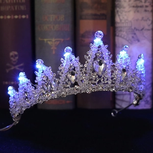 Detail view of silver bridal crown with sparkling crystals and integrated blue LED lights