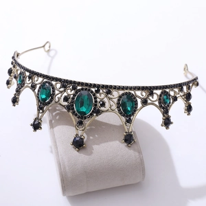 Detail view of vintage bronze bridal crown with dark green and black crystal gemstones