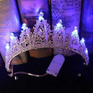 Close-up of luxury bridal crown with purple LED lights and silver rhinestone detailing