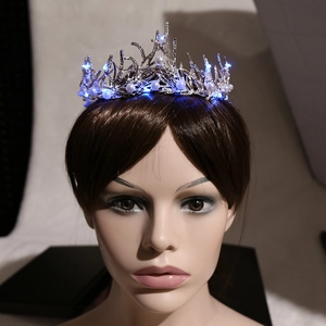 Elegant bridal crown with blue LED lights and white pearls on silver metal frame