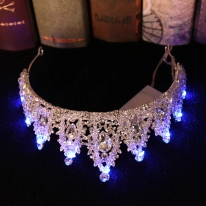 Detailed close-up of a silver tiara with blue LED lights and sparkling rhinestones