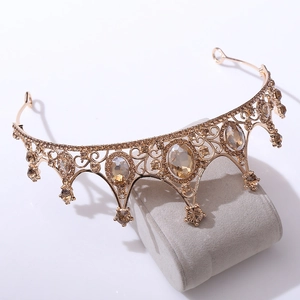 Detailed view of ornate gold bridal tiara with amber crystals and fine rhinestones