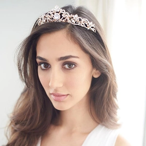 Elegant rose gold bridal crown with crystal rhinestones on a model for wedding hairstyles