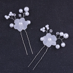 Handmade bridal hair pins set with elegant pearls and crystal flower accents on silver wires