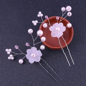 Detailed close-up of handmade pink floral hair pins with pearls and crystal beads