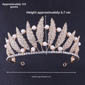 Detailed view of a golden leaf crown with pearls and rhinestones, 6.7cm height