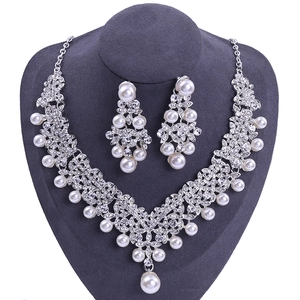 Elegantes Brautschmuck-Set mit weißen Perlen und funkelnden Strasssteinen auf Silberlegierung