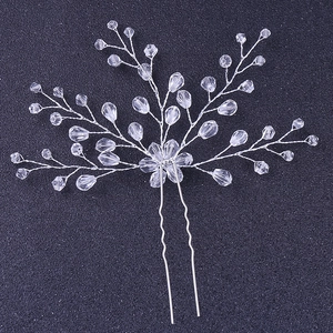 Detail view of handmade crystal bridal hair pin with silver wire floral arrangement