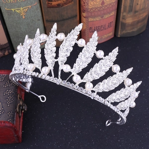 Baroque silver bridal crown with pearls and rhinestones on a vintage background
