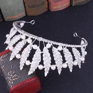 Elegant Baroque leaf bridal crown with silver rhinestones and white pearls on dark surface