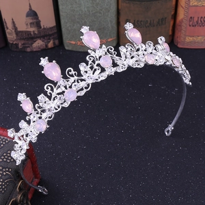 Detailed view of silver bridal crown with pink teardrop crystals and hollow metal work