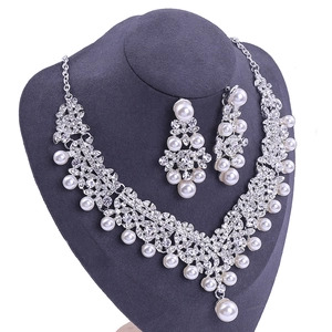 Details des silbernen Brautschmuck-Sets mit floralen Strasssteinen und weißen Perlen