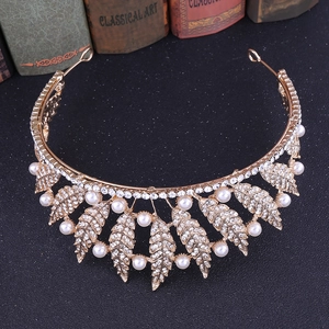 Detailed macro view of golden leaf crown with inlaid rhinestones and white pearls