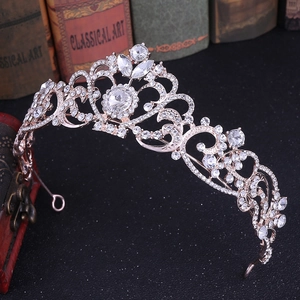Detailed macro view of rose gold bridal crown with crystal rhinestones on vintage surface
