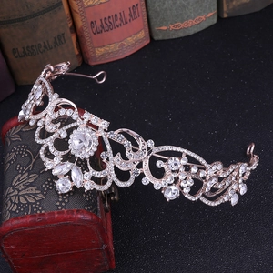 Macro detail of rose gold bridal crown with crystal rhinestones on a vintage book