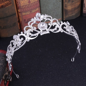 Close-up of silver rhinestone crown showing intricate marquise and heart-cut crystal details