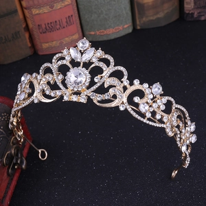 Close-up of rose gold rhinestone crown with intricate floral patterns and vintage book decor