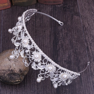 Detailed macro view of retro baroque silver crown with white pearls and rhinestones