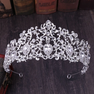 Detailed macro shot of silver bridal tiara with intricate rhinestones on vintage books