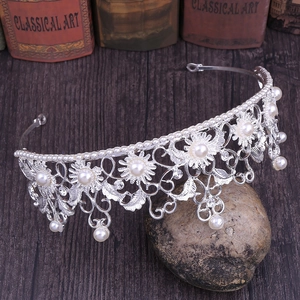 Macro detail of vintage baroque silver sunflower bridal crown with pearl embellishments