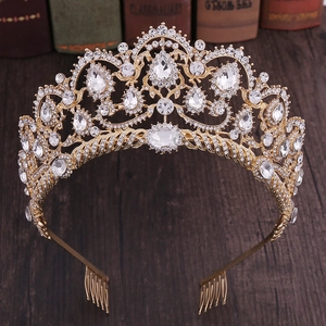 Luxurious gold crystal bridal crown with rhinestones and comb on a vintage wood background