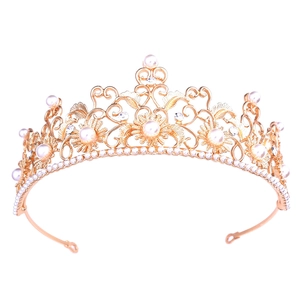 Close-up of golden baroque sunflower bridal crown with white pearls and sparkling rhinestones